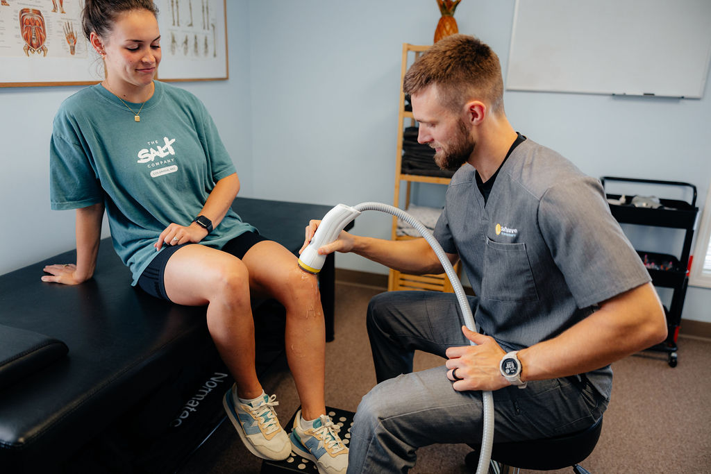 Derek Parker treating a client with SoftWave therapy at SoftWave By MoloTherapy in Columbia, MO